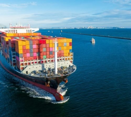 Aerial side view of cargo ship carrying container and running for export  goods  from  cargo yard port to custom ocean concept technology transportation , customs clearance.